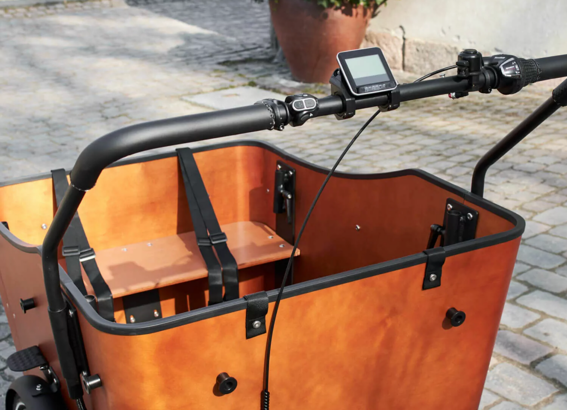 Close up shot of the Amcargobike Ultimate Harmony cargo bike, detailing the handlebars, LCD display and wooden box.