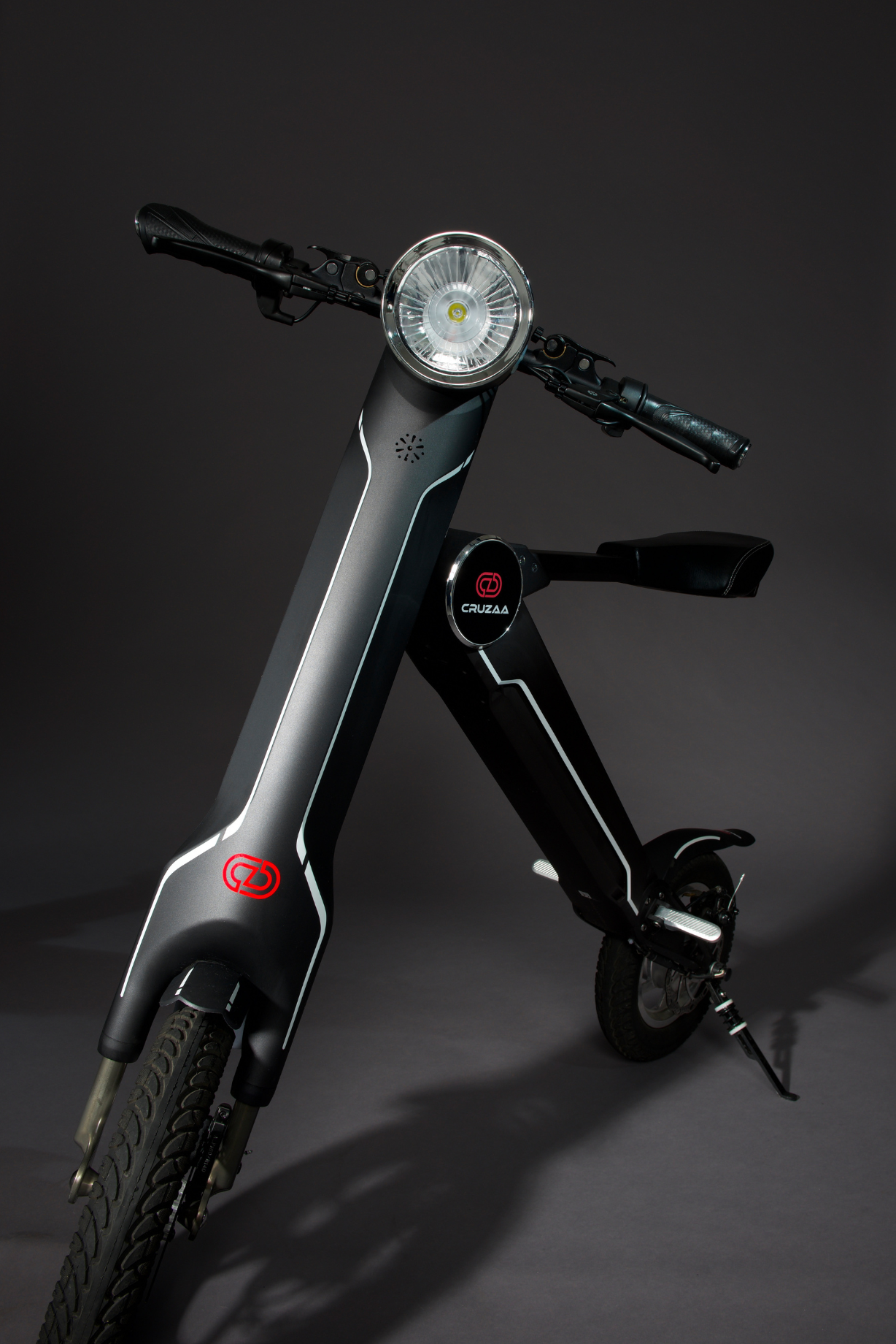 The Cruzaa E-Scooter Pro in Carbon Black standing in a studio setting. 