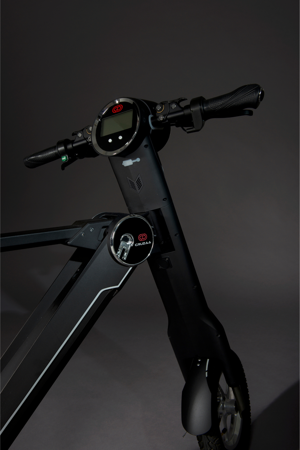 The Cruzaa E-Scooter Pro in Carbon Black standing in a studio setting, showing details of the headlight and logo. 