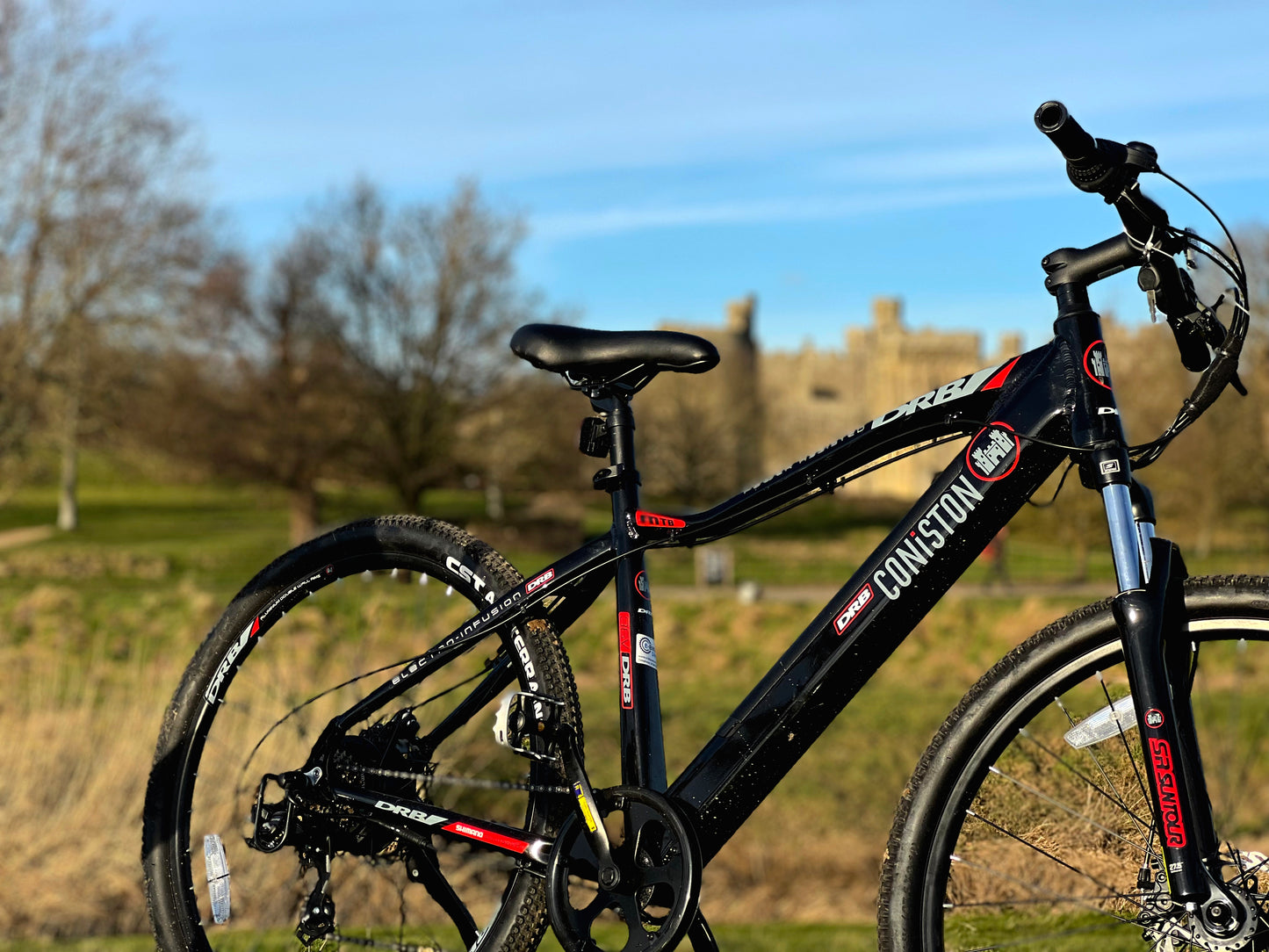 Lifestyle shot of the Dallingridge Coniston model in black and red, standing in a medieval landscape. 