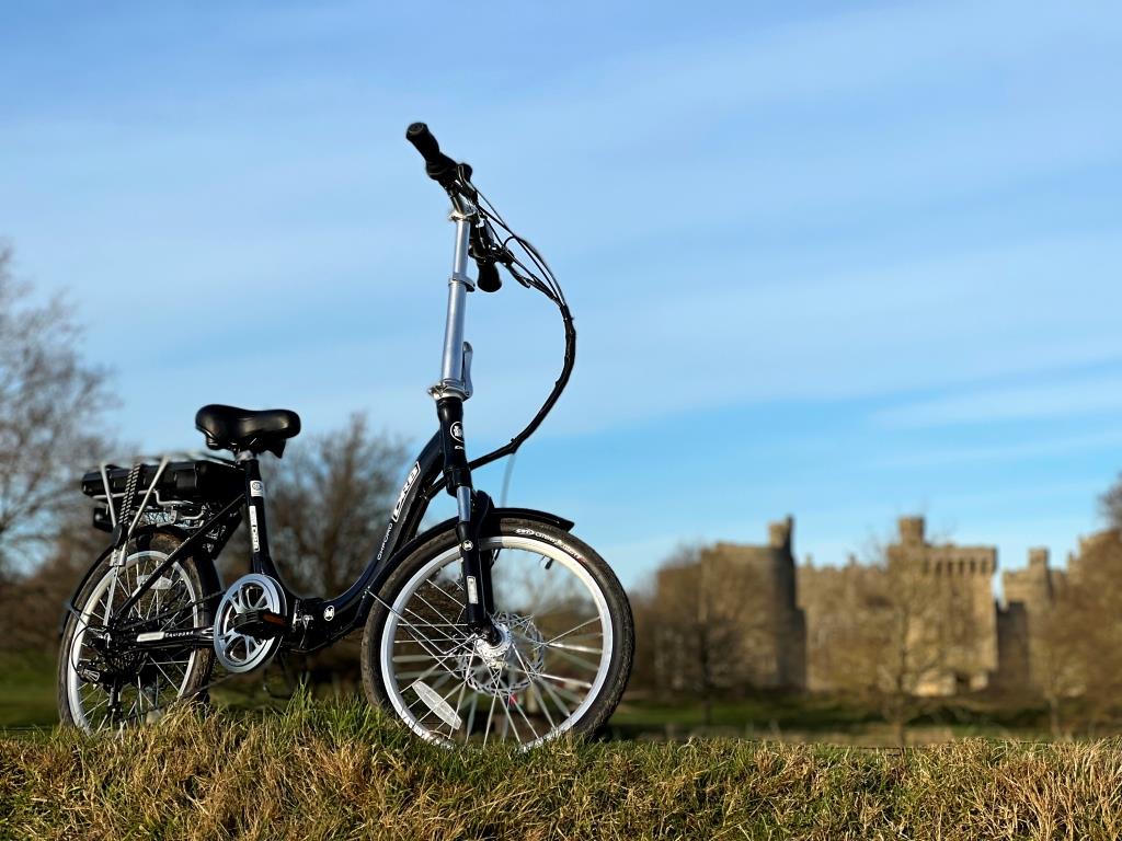 Lifestyle shot of the Dallingridge Oxford model in black, standing in a medieval setting. 